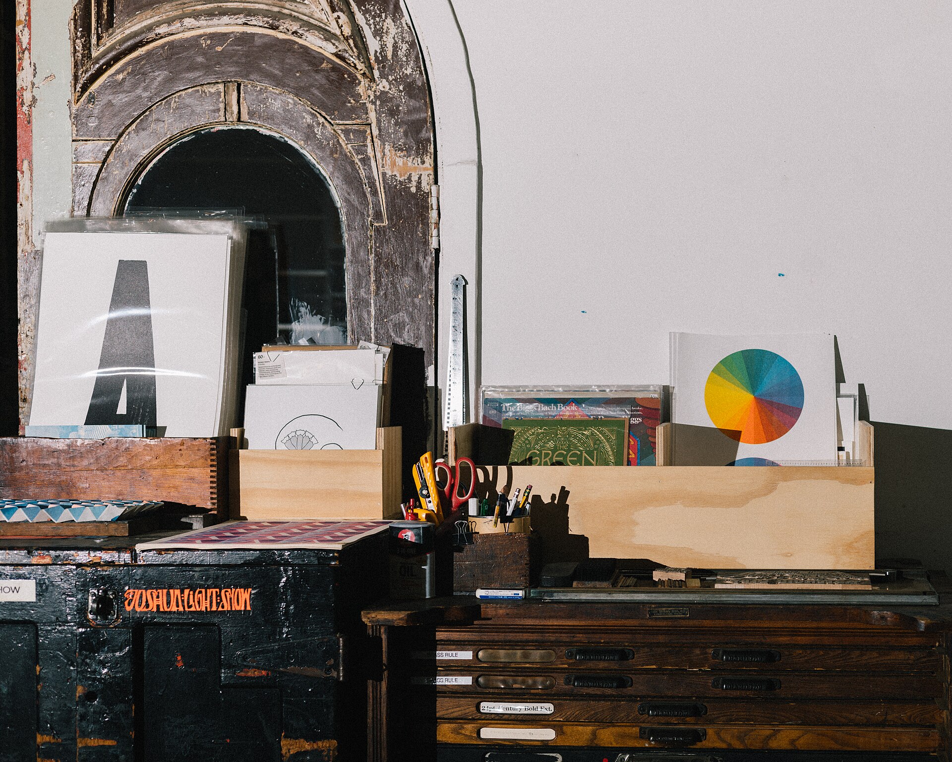 Printed artwork and materials on the counter at The Arm Letterpress